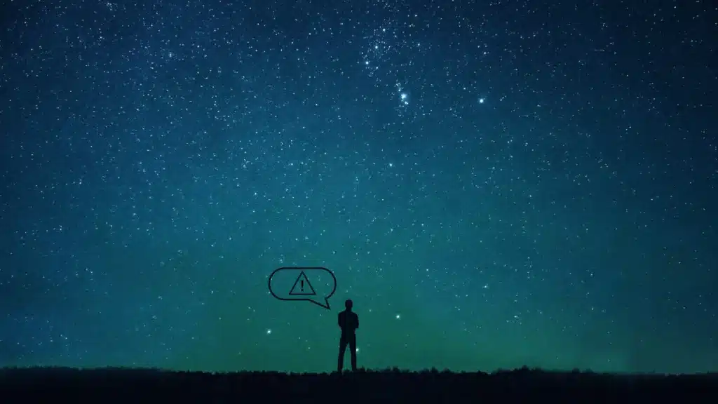 Shadow figure under a starry sky with warning symbol – representing inner unrest, intuitive signals, and the beginning of reflection in The Last Hour Experience.